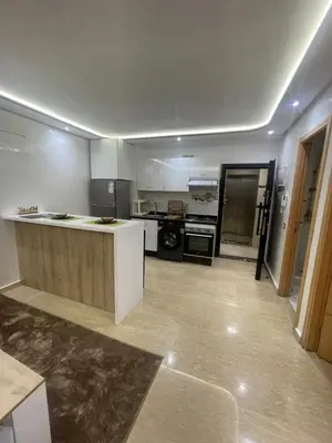 a large kitchen with a counter in a room at Studio Chic & Neuf au Cœur de Bourgogne in Casablanca-Port