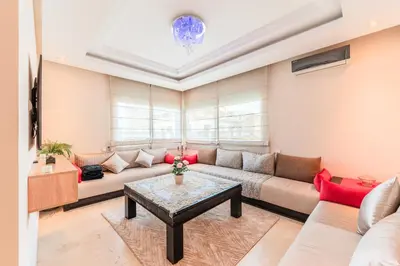 a living room with a couch and a table at Confort Urbain - Plein centre & Spacieux in Casablanca