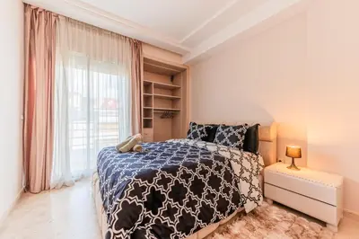 a bedroom with a bed and a large window at Confort Urbain - Plein centre & Spacieux in Casablanca