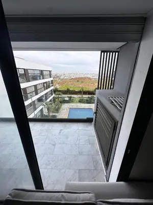 a balcony with a view of a swimming pool at appartement de luxe a Mansouria in Mansouria