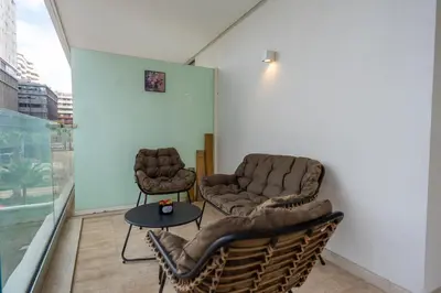 two chairs and a table in a room at Modern CFC Flat with Terrace Gym & City Views in Casablanca