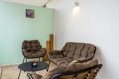 two chairs and a table in a room at Modern CFC Flat with Terrace Gym & City Views in Casablanca