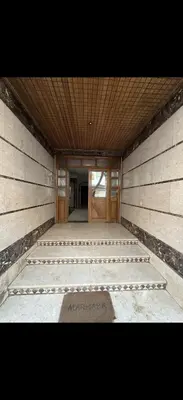 a building with a hallway with a door and stairs at Chez baya in Rabat