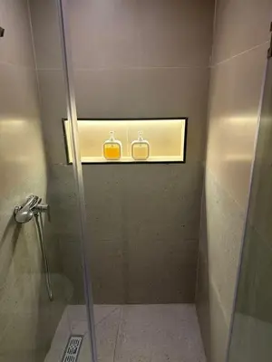 a bathroom with a shower stall with two toilets at Studio Premium Maarif in Maarif