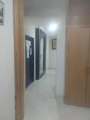 a hallway with three doors in a room at اقامة جنان تمارة تمارة in Temara