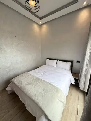 a bedroom with a large white bed in a room at Appartement Haut Standing in Casablanca
