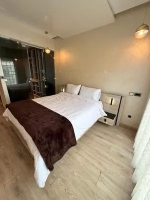 a bedroom with a large bed with white sheets at Appartement Haut Standing in Casablanca