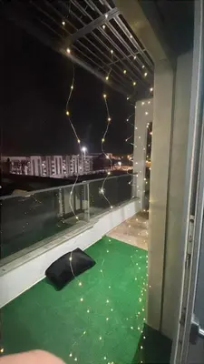an umbrella on the floor of a balcony at night at Appartement magnifique et moderne in Temara