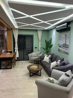 a living room with a couch and a table at Élégant & Spacieux - Résidence Sécurisée à Témara in Temara