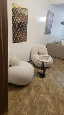 a living room with two chairs and a table at Stunning 2 bedrooms flat Palmier in Casablanca