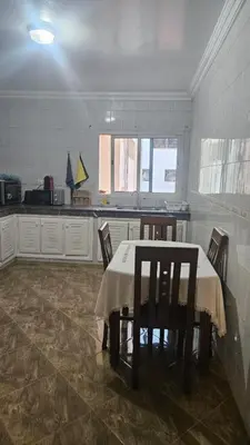 a kitchen with a table and chairs in a room at Stunning 2 bedrooms flat Palmier in Casablanca
