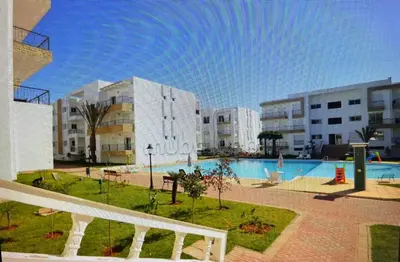 a view of a swimming pool in a building at Appartement al yakout 1 in Mansouria