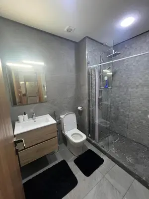 a bathroom with a toilet and a sink and a shower at El Mansouria Mohammedia, Magic House T5 in Mansouria
