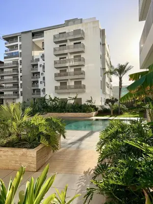 a swimming pool in front of a building at Luxury 1BR CFC with Pool, Balcony & City View in Casablanca