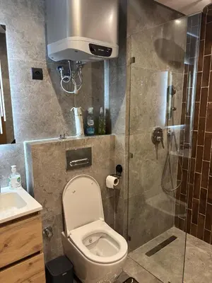 a bathroom with a shower with a toilet and a sink at Bridge Collection - Mirage in Casablanca
