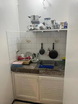 a kitchen counter with a sink and some pots and pans at Agdal Rabat superb furnished modern studio with large terrace in Rabat