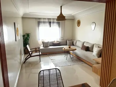 a living room with a couch and a table at Charmant appartement in Casablanca center city in Casablanca