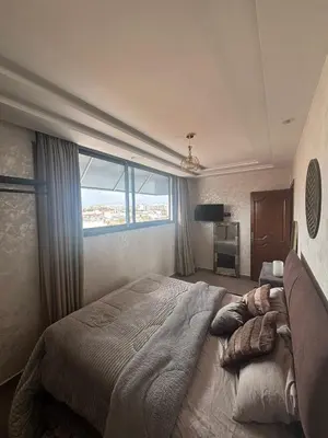 a bedroom with a large bed with a large window at studio elevator, renovated air-conditioned breakfast in Casablanca