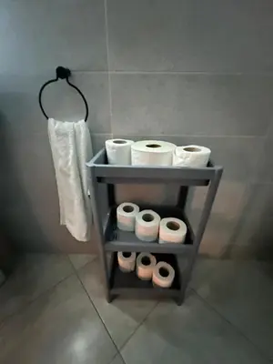 a shelf with four rolls of toilet paper in a bathroom at Cozy appartement avec piscine in Bouznika