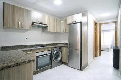 a kitchen with a stainless steel refrigerator and a dishwasher at Studio Paisible aux Hopitaux Wifi & Parking in Casablanca