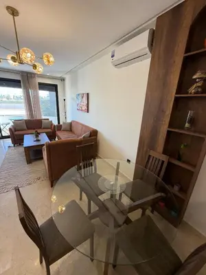 a living room with a glass table and chairs at Cozy studio for rent for respectful family couple in Casablanca