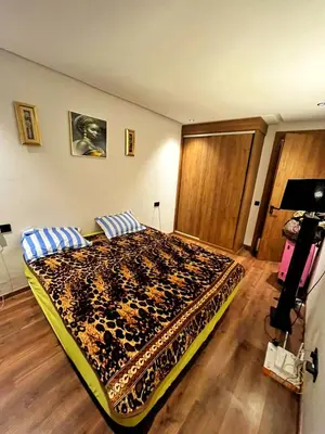 a bedroom with a large bed in a room at Les-iris-Appartement-moderne-chambre-salon-au-cœur-de-Casablanca in Casablanca