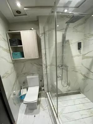 a bathroom with a toilet and a glass shower at Urban Square in Casablanca