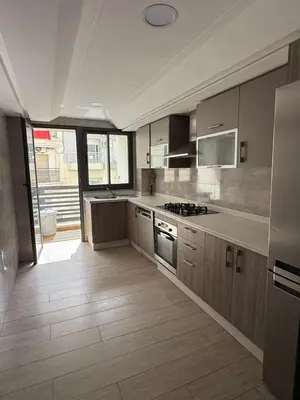 a kitchen with stainless steel appliances and wooden cabinets at Urban Square in Casablanca