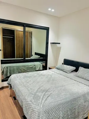 a bedroom with two beds and a large mirror at Located at Building 55, Golden Pavilion, 3rd Floor in Casablanca