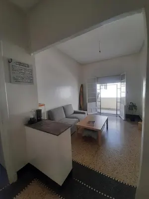 a living room with a couch and a table at Cozy Studio with Balcony, Casa Center Close to Everything in Casablanca