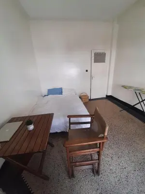a bedroom with a bed and a table and a bench at Cozy Studio with Balcony, Casa Center Close to Everything in Casablanca