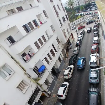 a city street with cars parked next to buildings at Cozy Studio with Balcony, Casa Center Close to Everything in Casablanca