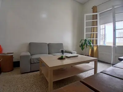 a living room with a couch and a coffee table at Cozy Studio with Balcony, Casa Center Close to Everything in Casablanca