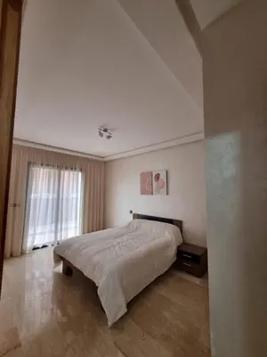 a bedroom with a large bed and a window at Maarif Cosy Studios in Casablanca