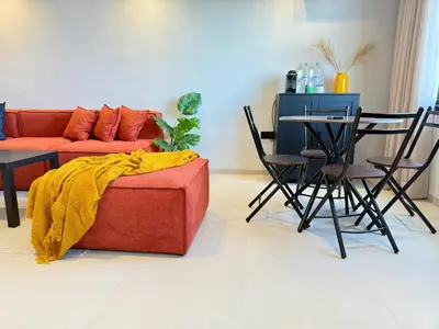 a living room with a couch and a table with chairs at Appartement moderne et chaleureux au cœur de Rabat in Rabat