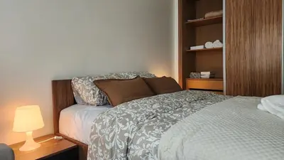 a small bedroom with a bed and a lamp at Appartement modern tramway in Casablanca
