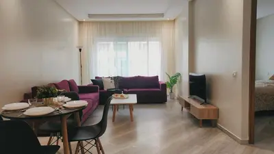 a living room with a purple couch and a table at Appartement modern tramway in Casablanca