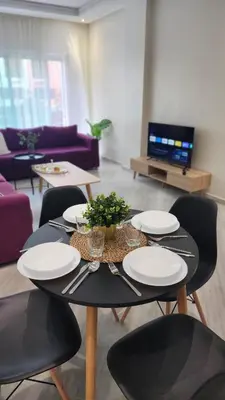 a table with plates on it in a living room at Appartement modern tramway in Casablanca