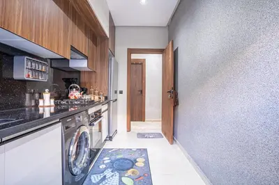 a kitchen with a washer and dryer in a room at Luxury Residence Beach Gym and Garage in Pont Blondin