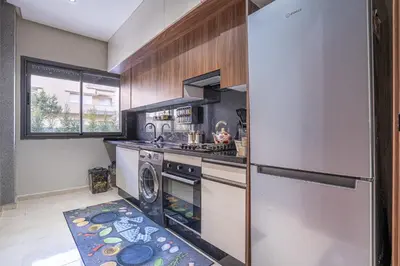 a kitchen with a stove and a refrigerator at Luxury Residence Beach Gym and Garage in Pont Blondin