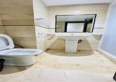 a bathroom with a toilet and a sink and a mirror at Familly Residence in Casablanca