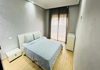 a small bedroom with a bed and a window at Familly Residence in Casablanca