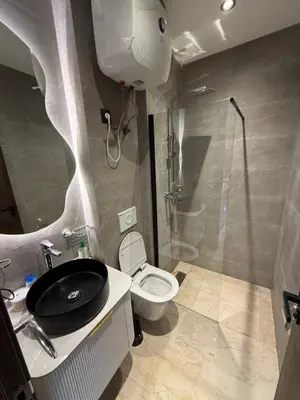 a bathroom with a toilet and a sink and a shower at Suite Apartment Maarif Val Fleurie à louer in Casablanca