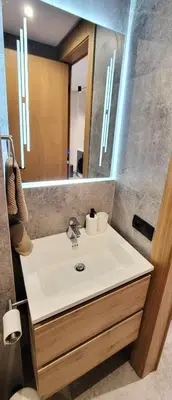 a bathroom with a sink and a mirror at Appartement moderne avec parking, toit terrasse et salle de sport - Anfa Park in Casablanca