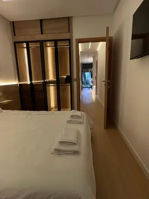 a bedroom with a bed with two folded towels on it at Central T1 cozy and chic in Rabat