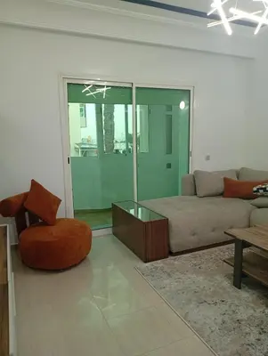 a living room with a couch and a chair at Oceania in Mohammedia