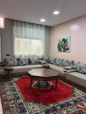 a living room with a couch and a table at Cozy Apartment Rabat in Rabat