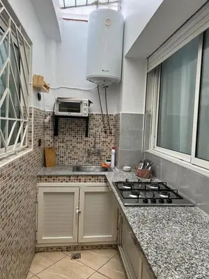 a kitchen with a sink and a stove in it at Cozy Apartment Rabat in Rabat