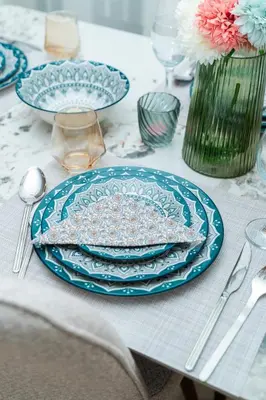 a table with blue plates and silverware on it at Elegant Studio at 2 Mars Modern, Quiet Convenient in Casablanca