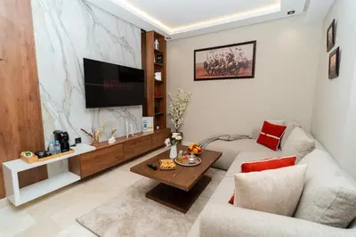 a living room with a couch and a table at Elegant Studio at 2 Mars Modern, Quiet Convenient in Casablanca